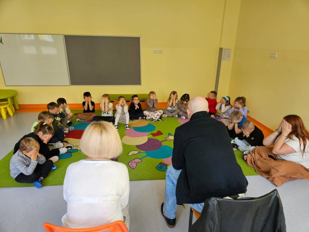 Dzieci zasłaniają dłońmi oczy. Na foto Łukasz Baruch i Karolina Żelichowska.